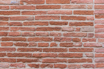 Naklejka premium Close-up shot of a wall made of red bricks