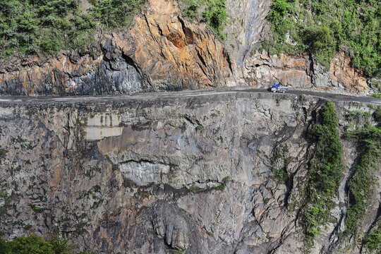 Narrow street in cliff with trucks, death road, Camino de la Muerte, Yungas road between La Paz and Coroico, Bolivia