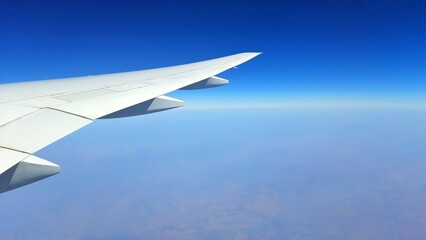 Airplane Wing in Flight Above Clouds © andi