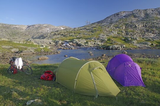 Two tents and a bike in the mountains, wild, barren mountain landscape, cycling trip, adventure, Rallarveien, Norway