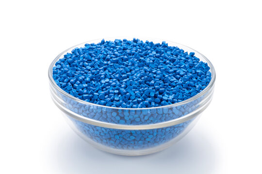 Blue masterbatch granules in a glass bowl isolate on white background. Masterbatch is a new type of colorant specifically for polymer materials