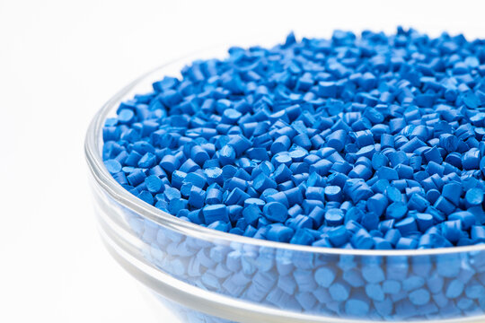 Blue masterbatch granules in a glass bowl. Masterbatch is a new type of colorant specifically for polymer materials