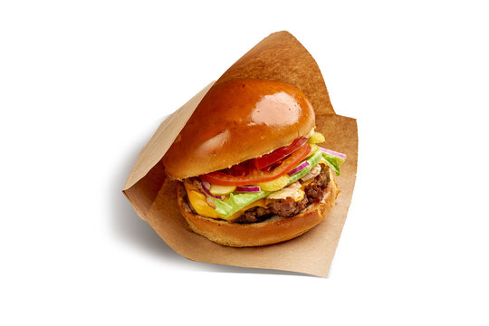 Fresh classic cheeseburger wrapped in craft paper isolated on white background