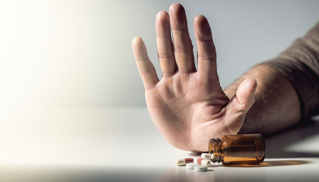 A powerful symbolic close-up of a human hand rejecting pills, representing the crucial fight against drug abuse and illicit trafficking, perfect for International Day awareness