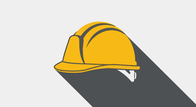 A bright yellow safety helmet with a dark shadow against a neutral background