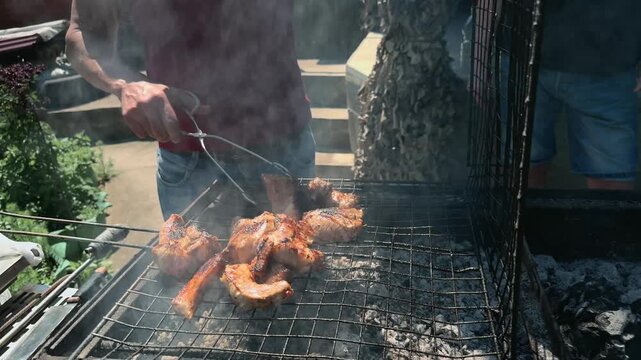 Anonymous Men Grilling Pork Meat on Charcoal BBQ in Backyard While Camera Pushes In Toward Smoky Extreme Close Up of Roasted Meat