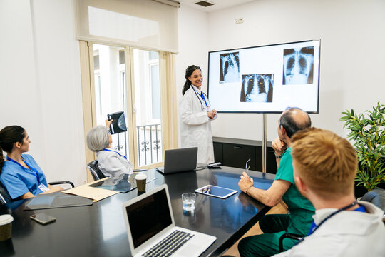Medical professionals presenting and analyzing chest x rays during a meeting, fostering collaboration and discussing patient care