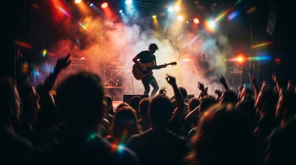 Fototapeta premium Musician playing guitar on stage in front of a cheering crowd at a concert
