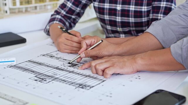 Close up hands of Architect and engineer. Team discussion about building construction. design brainstorming, sharing, talking about Structural design.