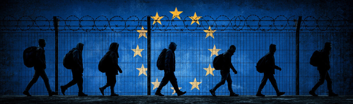 Migrant Journey: Silhouettes of migrants walking with backpacks towards a barbed wire fence with the European Union flag in the background, representing borders and migration challenges.