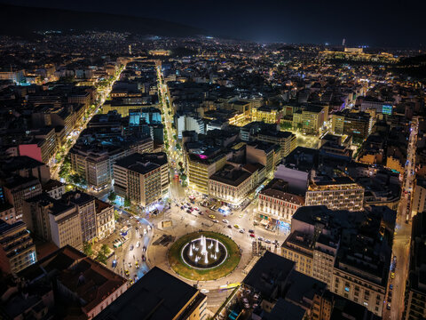 Aerial view of the illuminated city skyline of Athens, Greece, from Omonia Square until Parliament and Acropolis hill during night time