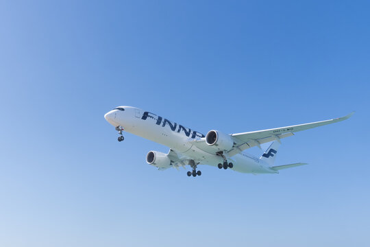 Phuket Thailand 30 11 2025: Finnair Airbus A350-900 modern aircraft landing against blue sky, advanced wide body jet, international aviation technology and sustainable air travel concept, editorial