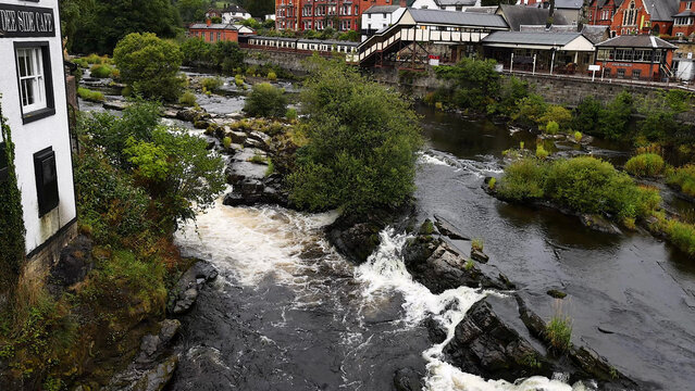 River Dee Rapids Flowing Past Historic Buildings and Llangollen Railway Station