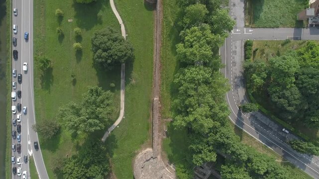 Aerial view of the ancient city walls and circular bastion surrounded by green parkland and urban roads in Ferrara, Emilia-Romagna, Italy.