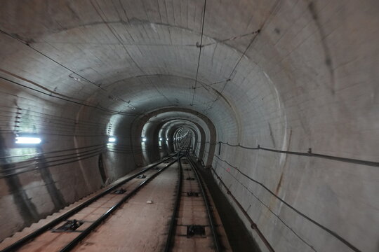 Deep perspective of a concrete cable car tunnel in Japan.