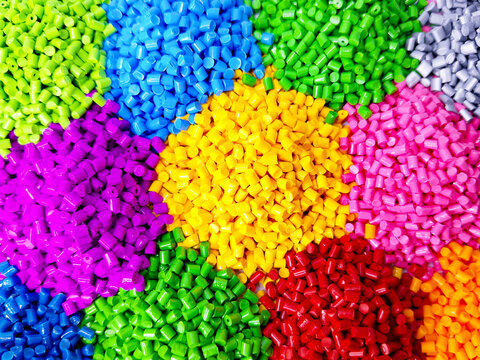 plastic masterbatch, colorful masterbatch granules as virgin polymer resin pigment, poured into white background media, suitable for industrial plastic company profile product catalog design