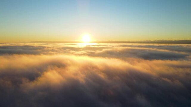Descending hyperlapse from sunrise above fog down to lake