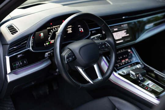 Steering wheel of electric vehicle cockpit electric buttons. Empty cockpit electric diesel hybrid vehicle, Head Up Display and digital speedometer. Autonomous car. Driverless car. Self-driving vehicle