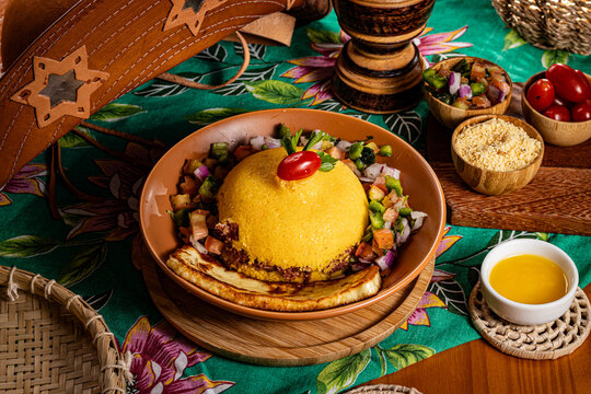 Traditional Brazilian Couscous with Carne de Sol, Queijo Coalho, Vinagrete, and Cherry Tomato Garnish