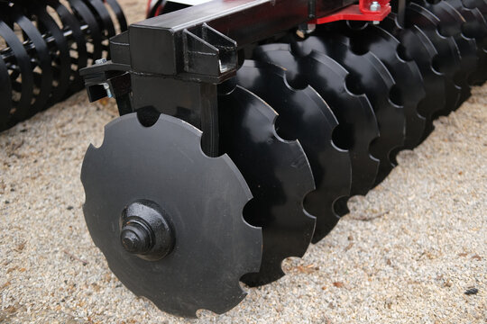 Disc harrow with heavy metal discs for soil tillage, breaking clods and preparing seedbeds on farm fields to improve moisture and root development