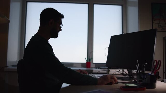 Person Working Diligently. Male Professional Typing On Keyboard Amidst Organized Workspace Environment. Media