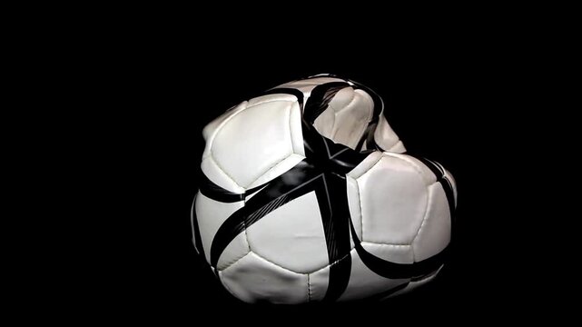 Soccer ball is deflating on a black background, close up.sports concept.