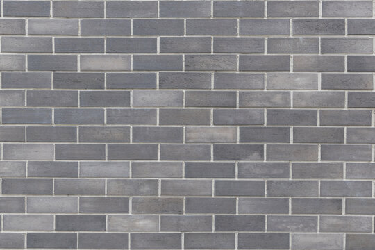 Black, dark grey brick wall texture background of mansory stone tile block pattern painted in gray color wallpaper modern interior and exterior and backdrop design