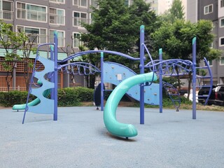 Colorful Kids Playground Surrounded by High Rise Apartment Buildings © 인우 배