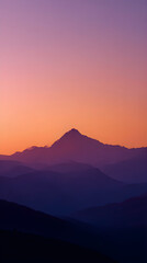 Fototapeta premium Minimal Mountain Peak Silhouette Against Orange Sunset Sky
