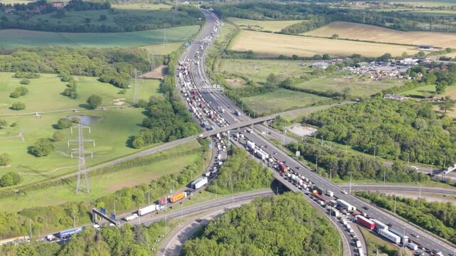 From an aerial viewpoint, many vehicles are stuck in a severe traffic jam on a multi-lane highway interchange.