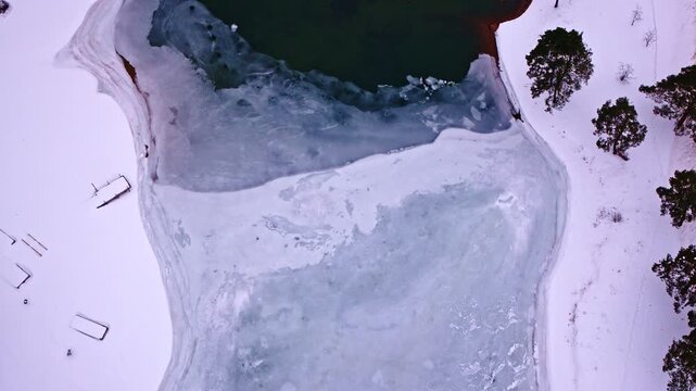 Drone shot looking down at frozen ice, water and snow near Sault Saint Marie Michigan