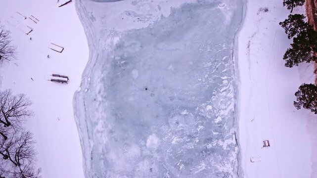 Drone shot looking down at ice and snow on frozen st marys river near Sault Saint Marie, MIchigan