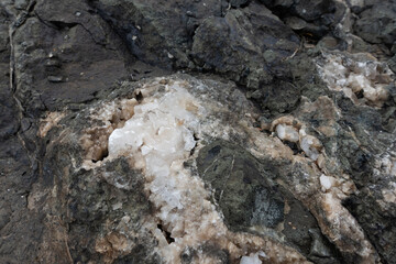 Fototapeta premium Close-up of a raw calcite mineral formation embedded within a dark rock matrix