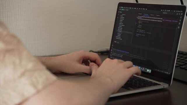 4K Close-Up of Software Developer Writing Code on Laptop in IDE