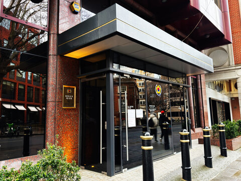 Entrance of the Republic of Korea embassy with glass facade and security bollards in London, UK