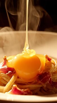 Hot Steaming Spaghetti Carbonara with Pouring Raw Egg Yolk