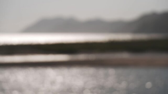 Sandbar landscape at a river mouth with mountain ranges in the background of a deep inlet
