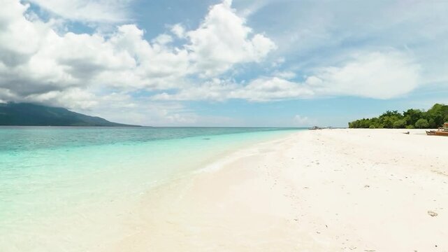 Boat over shoreline. White sandbar in Mantigue Island. Camiguin, Philippines.