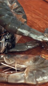 The shrimp falls on a wooden cutting board. Filmed on a high-speed camera at 1000 fps. High quality FullHD footage