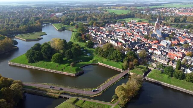 Naarden. Aerial view. Star-shaped fortified city surrounded by canals and bridges. Gothic Grote Kerk church. Star-shaped defensive fortress, 17th century.
Netherlands.