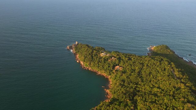 Aerial footage captures a lush peninsula jutting into the Atlantic Ocean near Ponta do Ara&ccedil;a. Ideal for travel or nature content.