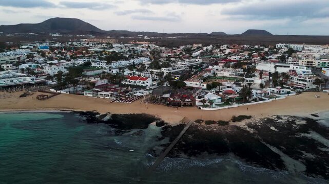 Aerial Pull Back Over Corralejo Beach and Waterfront Cityscape in Fuerteventura Canary Islands