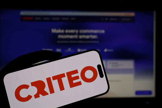 Kiel, Germany - 05-20-2026: Smartphone displaying French advertising technology company Criteo logo in front of companys webpage