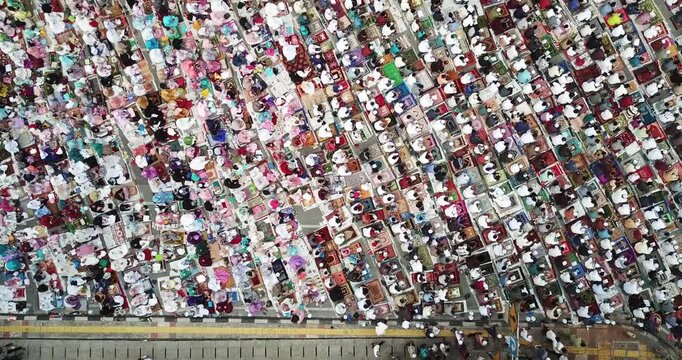 Top Down Aerial View of Large Crowd of Muslim People Praying Outdoors for Eid al-Fitr