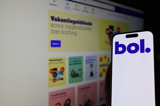 Kiel, Germany - 05-20-2026: Smartphone displaying Dutch ecommerce company bol.com logo in front of companys webpage