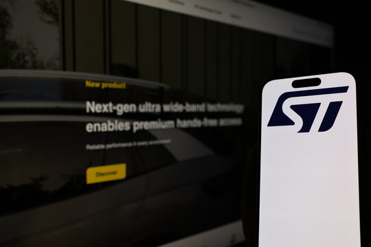 Kiel, Germany - 05-20-2026: Smartphone displaying Swiss semiconductor company STMicroelectronics logo in front of companys webpage