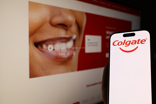 Kiel, Germany - 05-20-2026: Smartphone displaying US oral care company Colgate logo in front of companys webpage