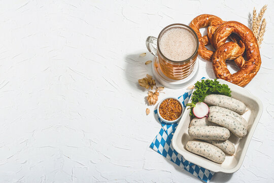 Traditional Oktoberfest set. Pretzels, beer, smoked pork knuckle eisbein with mustard