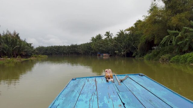 POV boat ride on tropical river with coconut trees Hoi An
