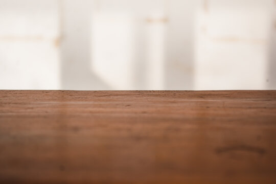 empty wooden table background with dirty and blurry wall background